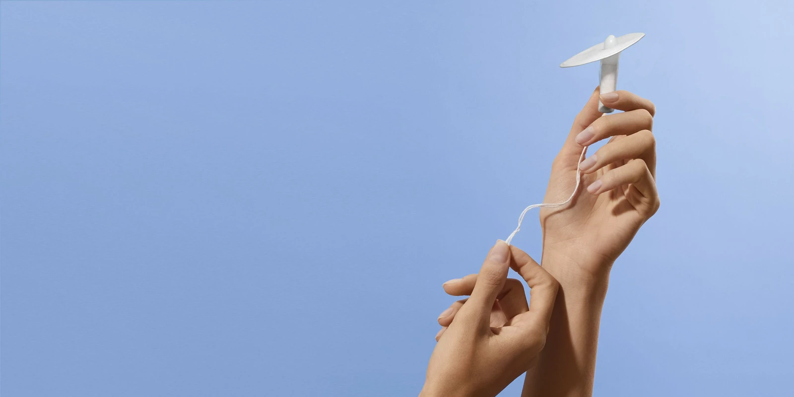 A Callavid device is held up against a light blue background