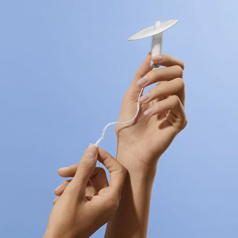 A Callavid device is held up against a light blue background